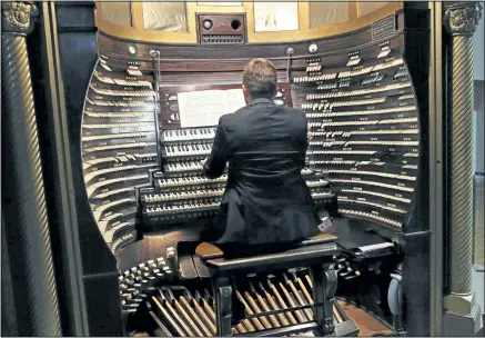  ?? MEL EVANS/ ASSOCIATED PRESS ?? Steven Ball, staff organist with the Historic Organ Restoratio­n Committee, plays the console of the huge Boardwalk Hall organ in Atlantic City.