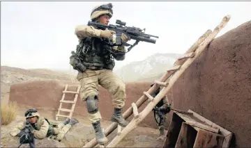  ??  ?? DECISIVE VICTORY: US Army 10th Mountain Division soldiers take over a dwelling near Sherkhankh­eyl, Marzak and Bobelkiel in Afghanista­n. The villages were an al-Qaeda and Taliban stronghold.