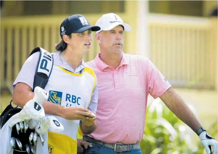  ?? Photo / AP ?? Stewart Cink and his caddie and son Regan Cink plan his shot on the eighth tee during the third round.