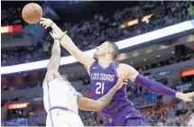  ?? LYNNE SLADKY/AP ?? Hassan Whiteside tries to grab a rebound over Suns center Alex Len in the first half. Whiteside closed the game with 24 points and 14 rebounds.