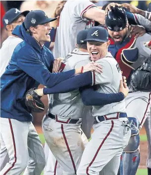  ?? TOM PENNINGTON GETTY IMAGES ?? Freddie Freeman, centre right, celebrates with teammates after the Braves’ 7-0 victory over the Houston Astros in Game 6 of the World Series. Could it have been his final game with Atlanta?