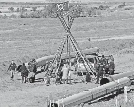  ??  ?? Law enforcemen­t officers, left, drag a person from a protest against the Dakota Access pipeline in October.