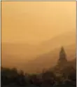  ?? ASSOCiAteD PReSS ?? Smoke from a wildfire spreads over woods, as seen from White Rock in Carmel Valley, southeast of Monterey, Calif., Wednesday.