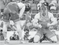  ?? Toshifumi Kitamura / AFP/Getty Images ?? Kyle Snyder, right, starts a long-awaited celebratio­n after holding off Azerbaijan’s Khetag Gazyumov to become the youngest American to win an Olympic wrestling gold medal, doing so at 20.