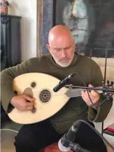  ??  ?? ILYA STRUMMING in his Moshav Luzit home – literally built from containers.