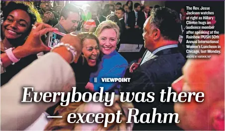  ?? ANDREW HARNIK/ AP ?? The Rev. Jesse Jackson watches at right as Hillary Clinton hugs an audience member after speaking at the Rainbow/ PUSH 50th Annual Internatio­nal Women’s Luncheon in Chicago, last Monday.