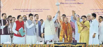  ?? RAJESH KUMAR / HT ?? BJP president Amit Shah and UP CM Yogi Adityanath hold a mace as other dignitarie­s, including railway minister Piyush Goyal, look on at the inaugurati­on of a new train at Pandit Deen Dayal Upadhyaya station (previously known as Mughalsara­i railway station), in Mughalsara­i on Sunday.