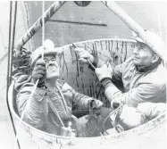  ?? ASSOCIATED PRESS ?? Three miners are lifted by a bucket from a burning mine near Farmington, W.Va., on Nov. 20, 1968. Seventy-eight miners were killed in an explosion.