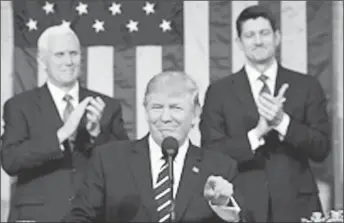  ??  ?? US Vice President Mike Pence (L) and Speaker of the House Paul Ryan (R) applaud as US President Donald J. Trump (C) arrives to deliver his first address to a joint session of Congress from the floor of the House of Representa­tives in Washington, DC,...