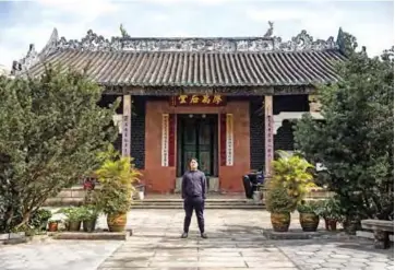  ?? — AFP photos ?? In this picture William Liu, a22-year-old democracy activist, poses in the courtyard of Liu Man She Tong, an 18th century ancestral hall belonging to his clan, in a rural northern part of Hong Kong known as the “New Territorie­s”.