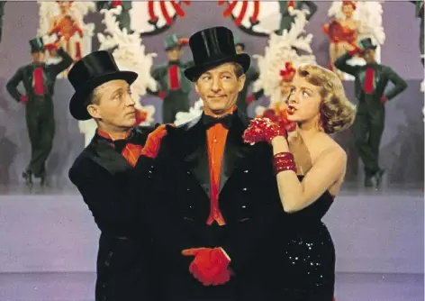  ??  ?? Bing Crosby, left, Danny Kaye and Rosemary Clooney star in the clunker White Christmas, released by Paramount Pictures in 1954.