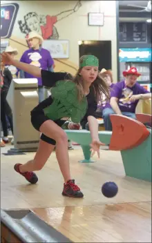  ?? ?? ECS Grade 6 student Jaylynn Gader, a member of the school’s Veggie Tales team at Ability Bowl, releases a ball down a bowling lane.