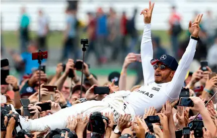  ?? — AP ?? Mercedes driver Lewis Hamilton celebrates after winning the British Formula One Grand Prix in Silverston­e on Sunday.