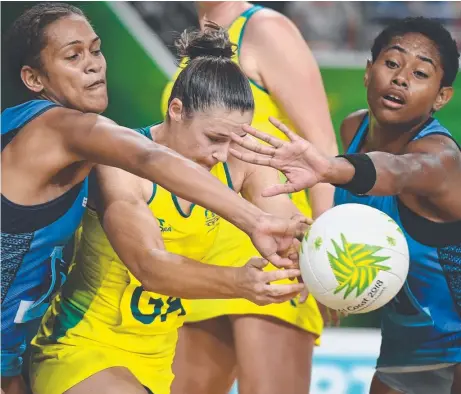  ??  ?? FAVOUR: Susan Pettitt battles her way through two Fiji defenders, and (below) Malawi make history. Picture: Getty Images