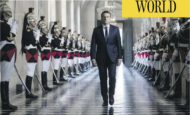  ?? ETIENNE LAURENT / AFP / GETTY IMAGES ?? French President Emmanuel Macron walks through the Busts Gallery at Versailles Palace, just outside of Paris, on his way to address a special congress of both houses of parliament, an event normally reserved for times of crisis or constituti­onal reform.