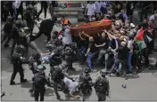  ?? MAYA LEVIN — THE ASSOCIATED PRESS ?? Israeli police confront mourners as they carry the casket of slain Al Jazeera veteran journalist Shireen Abu Akleh during her funeral in east Jerusalem on Friday.