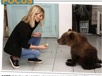  ??  ?? SAVED: Mollie King with cub Ushka, whose back legs were paralysed by poachers