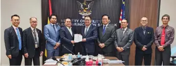  ?? ?? Julaihi (centre) hands over the gas aggregator appointmen­t from the Sarawak government to Janin, witnessed by Dr Abdul Rahman (fourth right) and others.