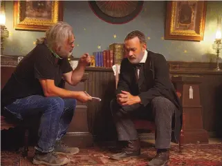  ??  ?? Director and co-writer Paul Greengrass and Tom Hanks on the set of “News of the World.”