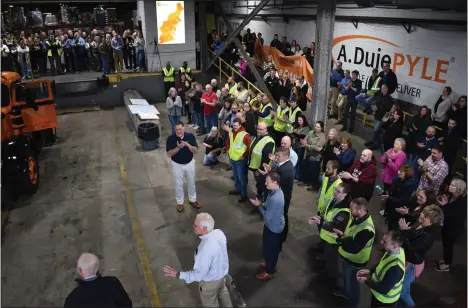  ?? PHOTO BY MATT WALDRON COURTESY A. DUIE PYLE ?? During a surprise celebratio­n, John Luciani, chief operating officer of LTL Solutions at A. Duie Pyle presents a restored 1951Autoca­r to Peter Latta, chief executive officer, second from left, as hundreds of employees applaud the moment April 1.