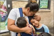  ?? RICHARD DREW / ASSOCIATED PRESS ?? Eilyn Carbajal reunites with her children in August at the Cayuga Center in New York. Immigrant families are facing tougher rules to take custody of children and relatives who crossed the U.S. border.