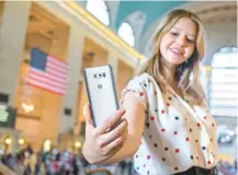  ?? Courtesy of LG Electronic­s ?? A model promotes the LG Electronic­s V30 smartphone at a Verizon store in New York. The handset was released in the United States, Thursday, through Verizon, AT&T, T-Mobile, Sprint and US Cellular.