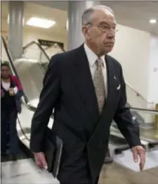  ?? J. SCOTT APPLEWHITE — THE ASSOCIATED PRESS ?? Senate Judiciary Committee Chairman Chuck Grassley, R-Iowa, walks through a basement passageway at the Capitol amid debates in the Senate on immigratio­n, in Washington, Wednesday. President Donald Trump is thanking Grassley for introducin­g legislatio­n...