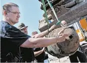  ?? HAYOUNG JEON/EPA ?? Dietmar Puepke shows off an unexploded World War II bomb discovered in April 20 in Berlin.