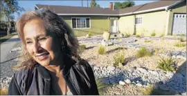  ?? Michael Robinson Chávez
Los Angeles Times ?? DORIAN CASTILLO of Granada Hills decided to turn her turf removal into a family project this summer after it was preapprove­d for more than $8,000.