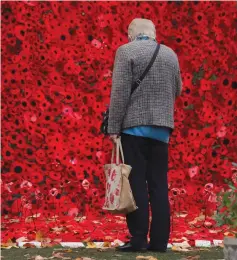  ?? (Andrew Couldridge/Reuters) ?? MORE THAN 15,000 poppies, handmade by local craft groups, schools and care homes, are displayed at Hertford Castle in Britain this week to mark the centenary of the end of the First World War.