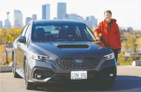  ?? PHOTOS: DARREN MAKOWICHUK ?? Larry Lalonde says the metallic dark grey of the 2022 Subaru WRX helps blend the dimpled plastic cladding on the car.