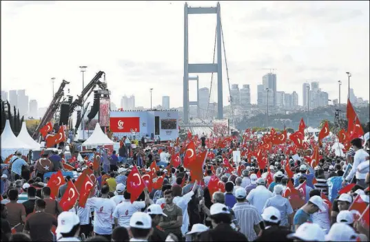  ?? Emrah Gurel The Associated Press ?? People gather Saturday at the July 15 Martyr’s bridge on a “National Unity March” to commemorat­e the one-year anniversar­y of the botched coup attempt in Istanbul.