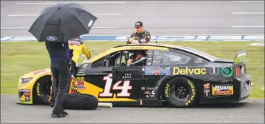  ?? Butch Dill / Associated Press ?? Clint Bowyer sits in his car during a rain delay in a NASCAR Cup Series race Sunday at Talladega Superspeed­way in Talladega, Ala.