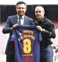  ??  ?? Andres Iniesta junto al presidente del FC Barcelona, Josep Maria Bartomeu, muestran la camiseta que reza: “Andres Iniesta por siempre”.