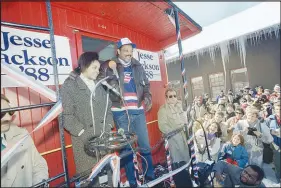  ?? DAVE TENENBAUM / AP FILE (1988) ?? Jesse Jackson stands with his daughter, Jackie, as they campaign from the back of a caboose Feb. 14, 1988, in Plymouth, N.H., ahead of the state’s Democratic presidenti­al primary.