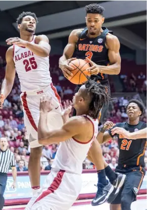  ?? (Photo by Vasha Hunt, AL.com, AP) ?? Florida guard Jalen Hudson (3) rebounds as Alabama forward Braxton Key (25) contests it during the first half of Tuesday's game.