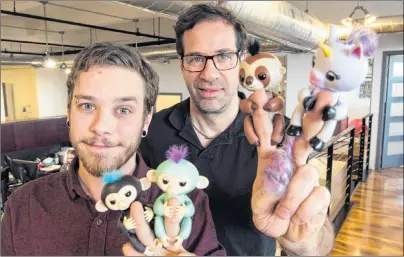  ?? CP PHOTO ?? Wowee creative director Benny Dongarra, right, and mechanical engineer Anthony Lemire hold Fingerling­s in Montreal on Dec. 7.