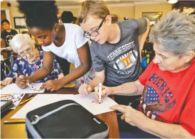  ?? STAFF PHOTO BY DOUG STRICKLAND ?? From left, Dorothy Frank, fourth-graders Amena Bennett and Peyton Alilson, and Bobbie Blackshear work together Tuesday to draw lines for Ozobot robots to follow at Life Care Center of Red Bank. Teacher Beth Wilson takes her class for active learning...