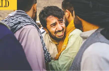  ?? MARCUS YAM / LOS ANGELES TIMES ?? A man grieves during a mass funeral in Kabul on Monday for members of a family killed in a U.S. drone airstrike.