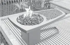  ?? Creators Syndicate photo ?? This modern table combines a small, open fire pit with a cocktail table.