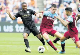  ?? AP ?? Manchester City’s Raheem Sterling vies for the ball with West Ham’s Declan Rice (centre), and Manuel Lanzini (right) during the English Premier League football match between West Ham United and Manchester City at London stadium in London yesterday.