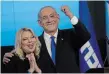  ?? THE ASSOCIATED PRESS FILE PHOTO ?? Israeli Prime Minister Benjamin Netanyahu and his wife Sara gesture after first exit poll results for the Israeli Parliament­ary election last fall.