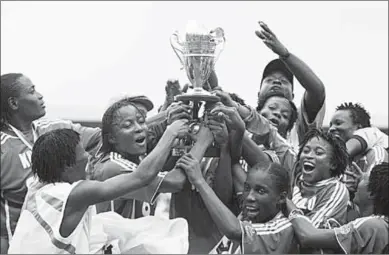  ??  ?? Nigeria’s female national team the Super Falcons in a 2006 photo after winning the national championsh­ip.
(Photo: AFP/Getty Images)