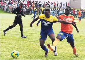  ?? FILE ?? St Elizabeth Technical High School’s captain Chris-Andrew Dixon (left) is challenged by Lennon High’s Cachje Jackson during an ISSA/FLOW daCosta Cup semi-final game at Manchester High School in 2016.