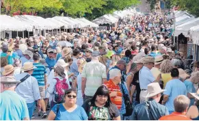  ?? JOURNAL ?? Thousands of people wander along the booths on Lincoln Avenue during the 96th annual Santa Fe Indian Market in August 2017.