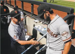  ?? Julie Jacobson / Associated Press 2018 ?? Giants manager Bruce Bochy, greeting Bumgarner late in a game last year against the Mets, says his ace “threw well” out of the bullpen Wednesday.