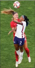  ?? The Associated Press ?? Team Canada’s Janine Beckie, left, and American Crystal Dunn battle for the ball during their semifinal soccer match, Monday, in Kashima, Japan.