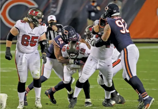  ?? JONATHAN DANIEL/ GETTY IMAGES ?? Khalil Mack sacks Buccaneers quarterbac­k Tom Brady during the third quarter of the Bears’ come- from- behind victory Thursday night.