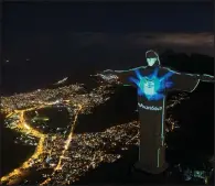  ?? (AP/Leo Correa) ?? The Christ the Redeemer statue in Rio de Janeiro is lit up Sunday as if it were wearing a protective mask. The message displayed across the statue says, “Mask saves.”