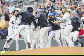  ??  ?? The Braves mob Brandon Phillips after his single to center field with no one out in 10th inning scored Johan Camargo with the winning run Saturday afternoon at SunTrust Park.